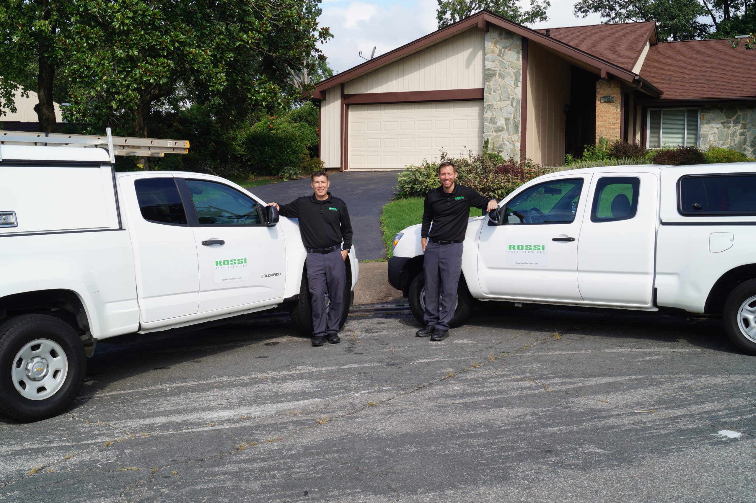 Jack Rossi and Joe Rossi with Rossi Pest Services fleet of service vehicles